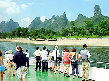 Visitors viewing the beautiful scenery of Li River on the cruise ship
